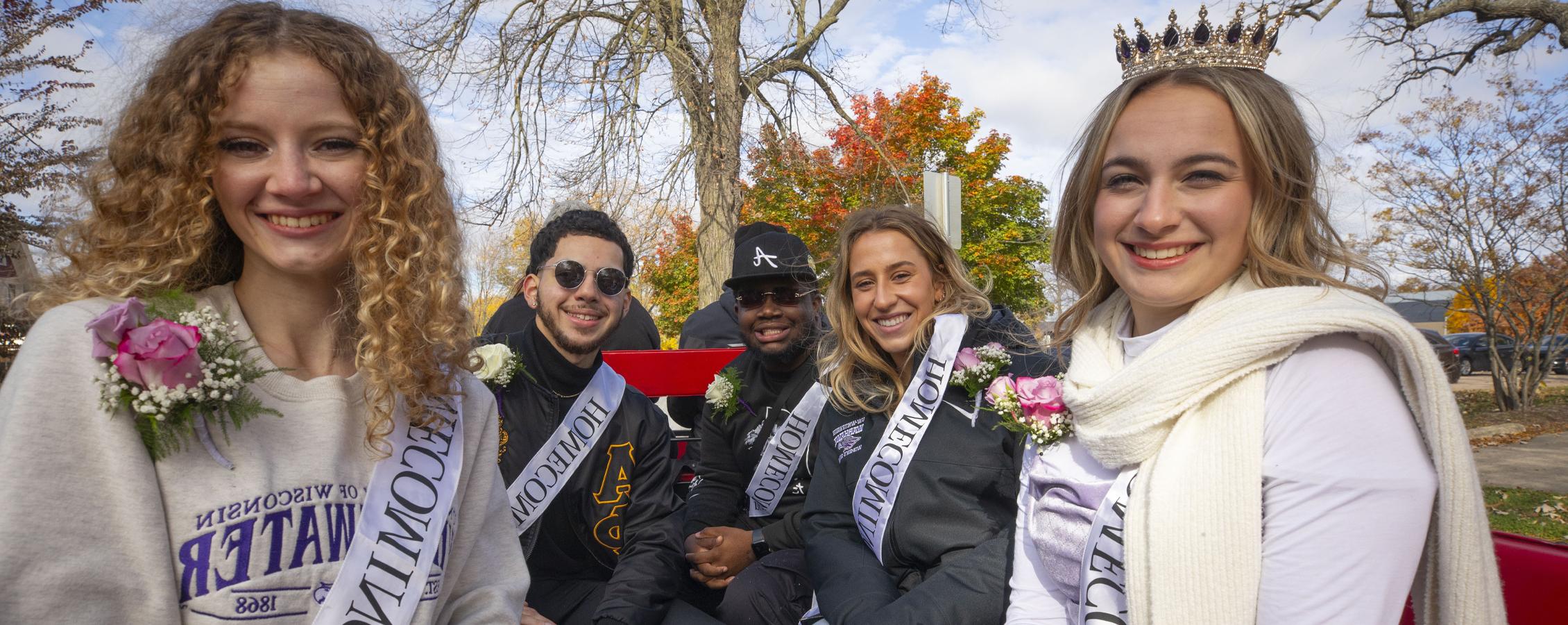 足彩平台's Homecoming Court sits on a float at the parade.