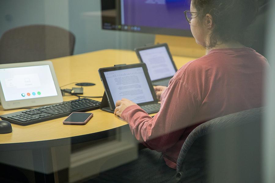 A person works on a laptop.